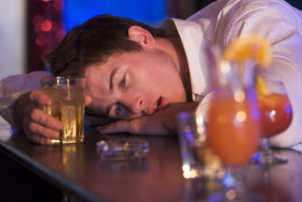 Drunk young man passed out in bar